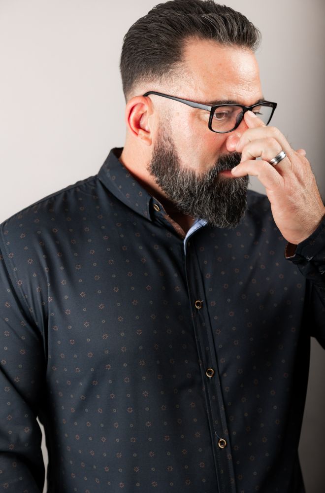 Barber with styled hair and beard